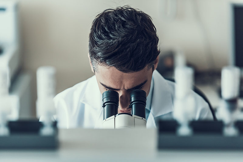 Dentist using a microscope