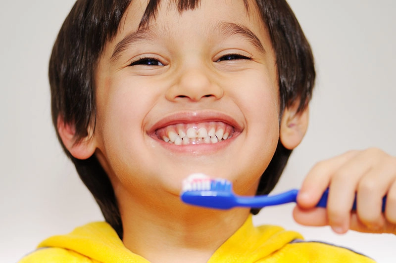 happy child brushing teeth