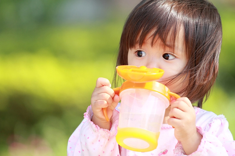 Little girl with sippy cup