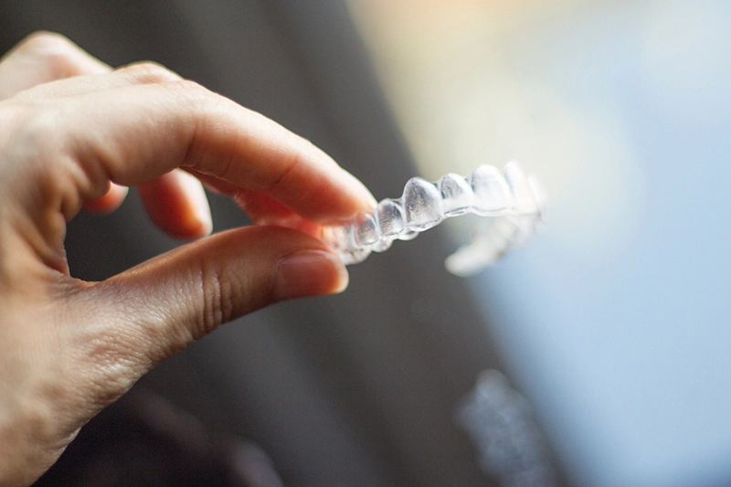 Woman holding dental aligner